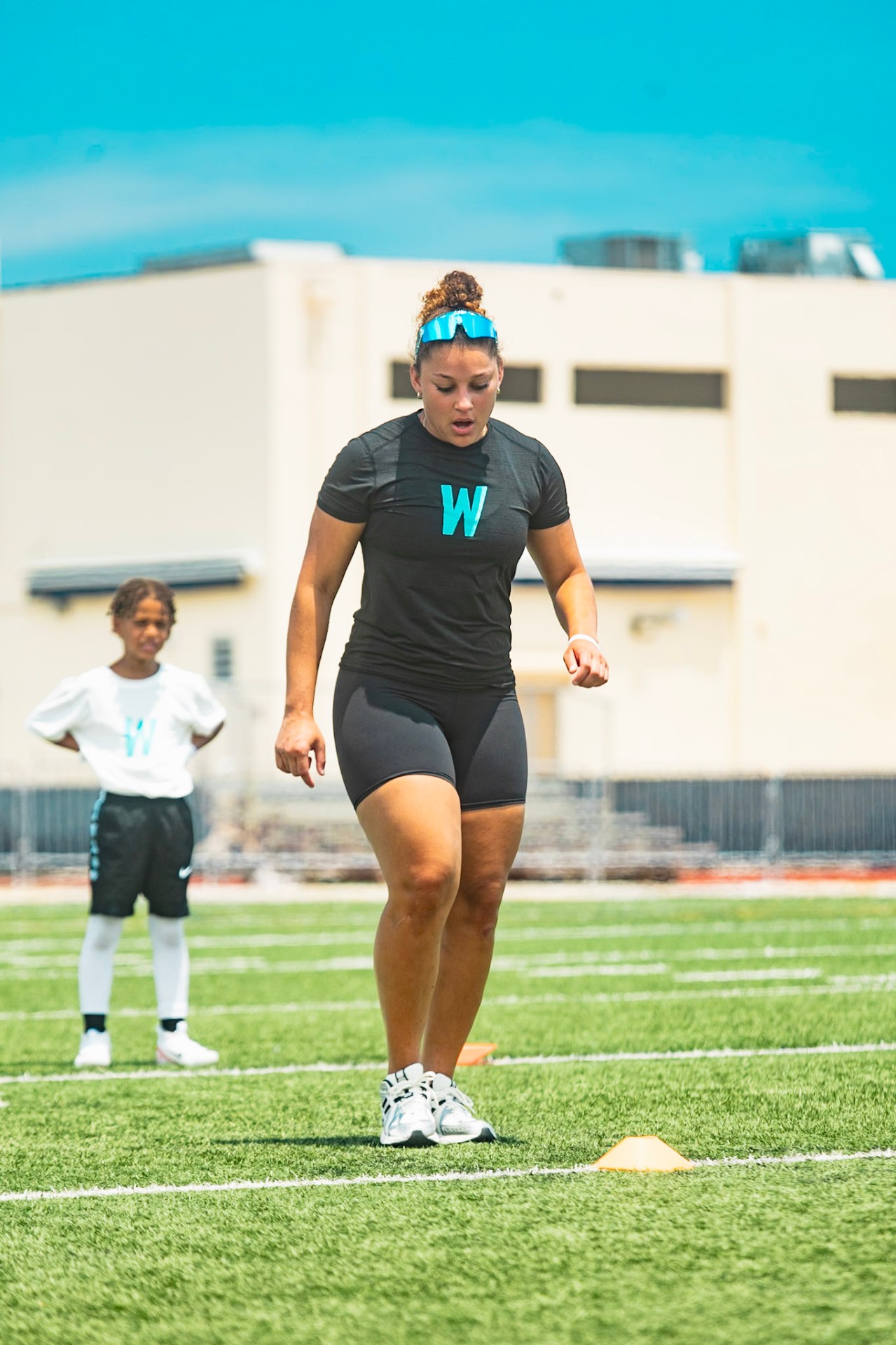 Sydney Hill coaching young athletes at the WeTrain football camp