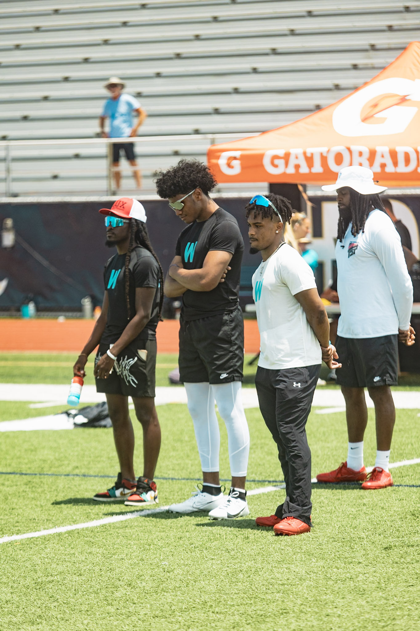 Group of athletes and trainers working drills on the field