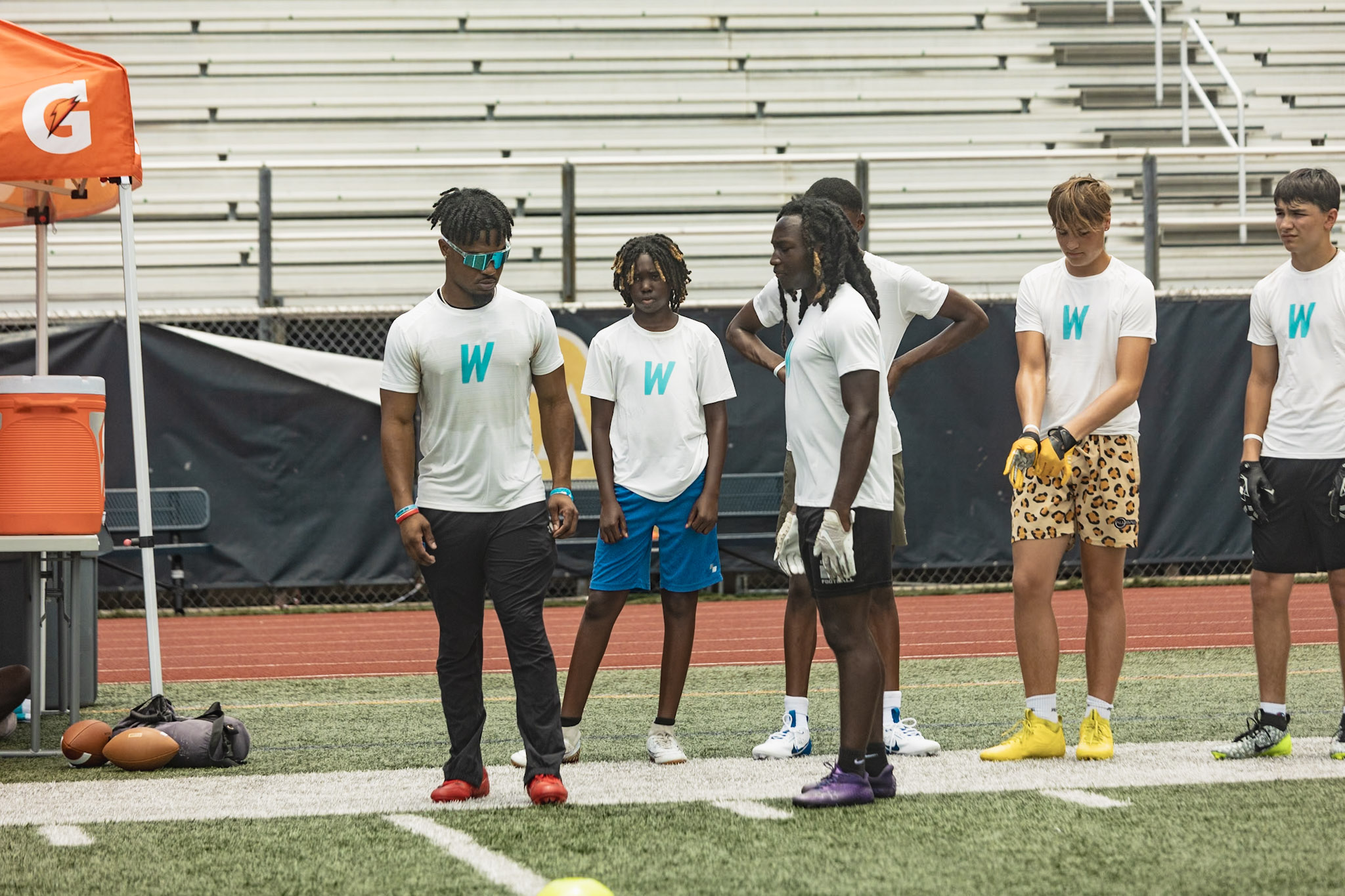 Campers lined up in WeTrain jerseys waiting for the next rep
