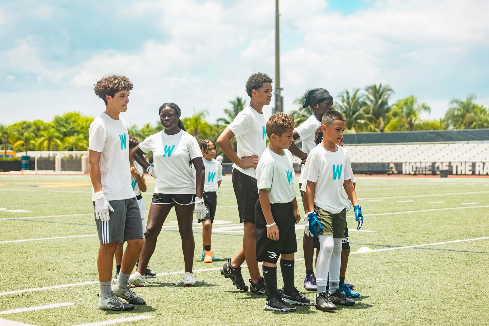 Young athletes at a WeTrain youth sports camp on a football field