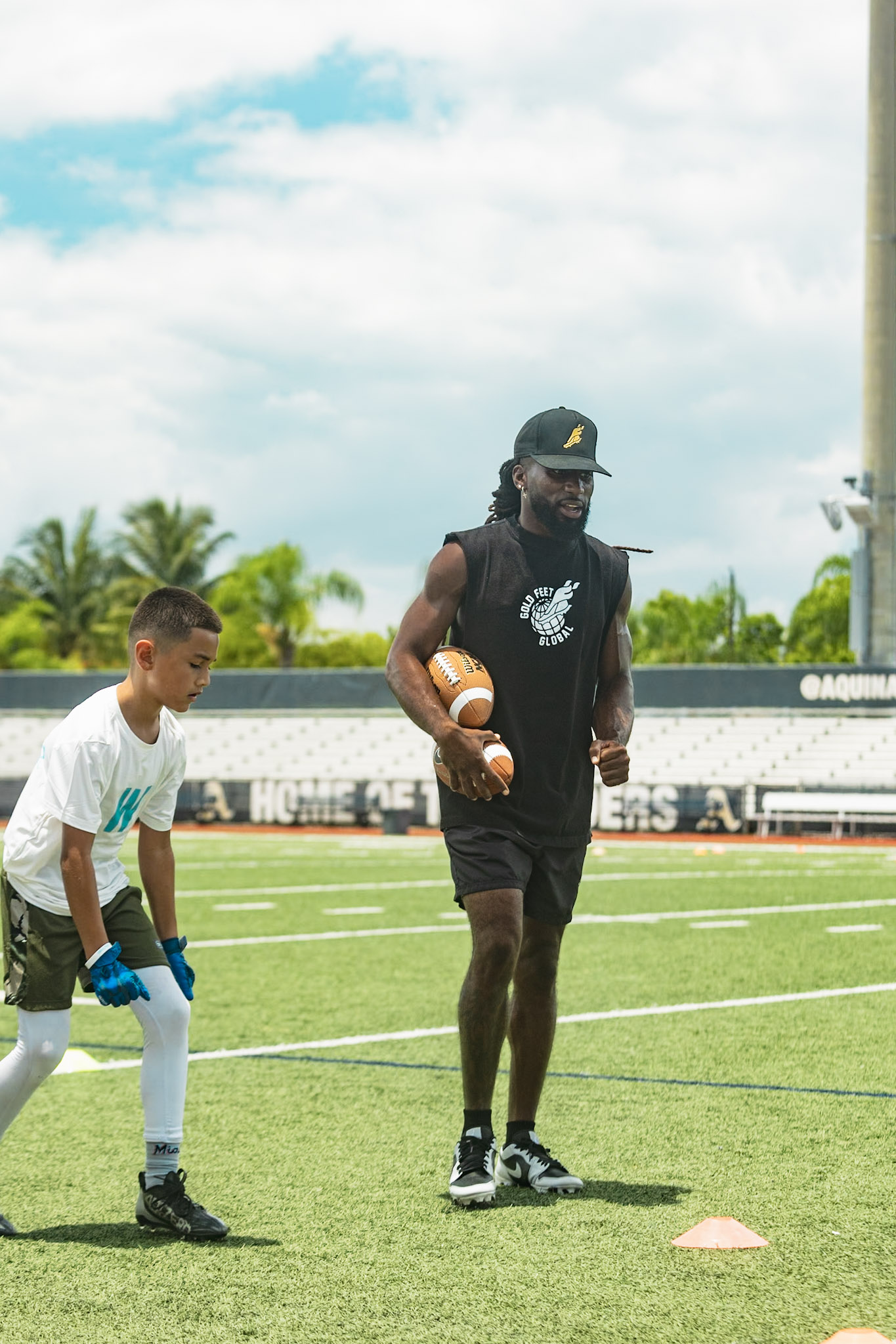 WeTrain trainer coaching a young camper through footwork drills