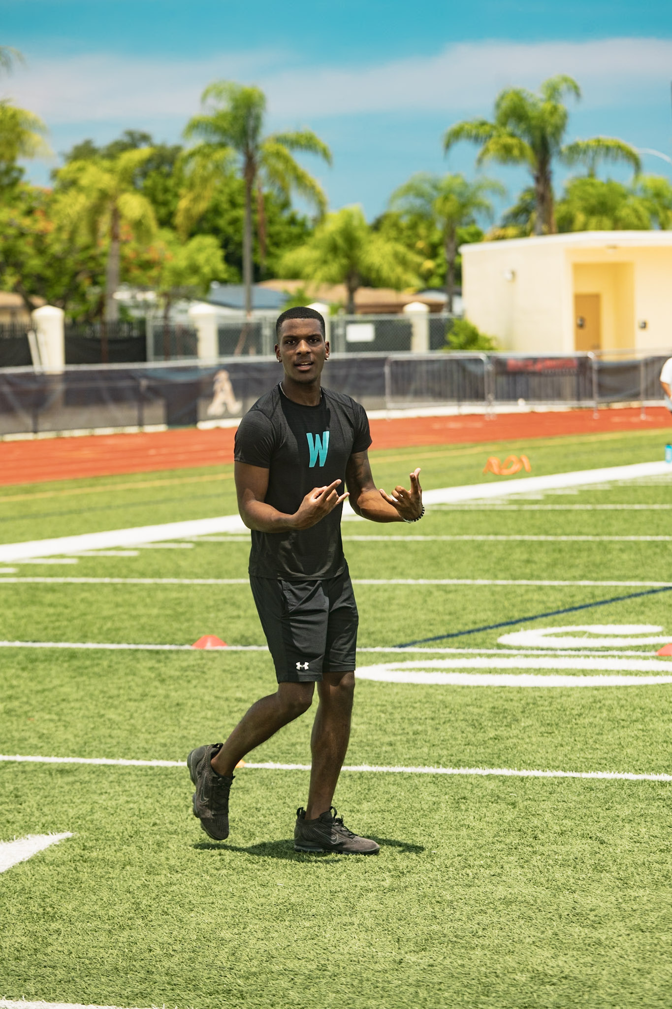 WeTrain trainer demonstrating a running route on the field