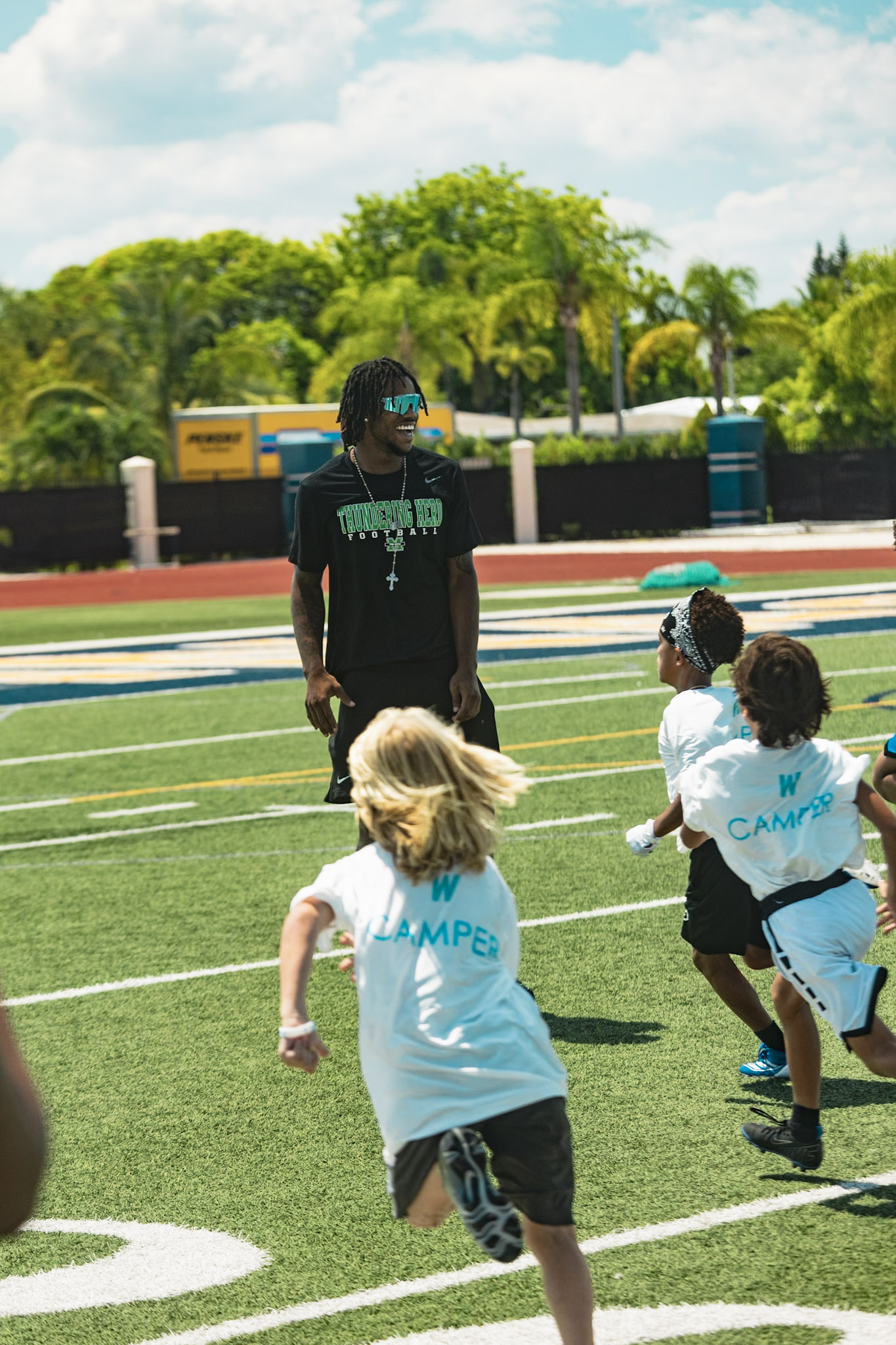 Kids sprinting through speed drills at the WeTrain football camp