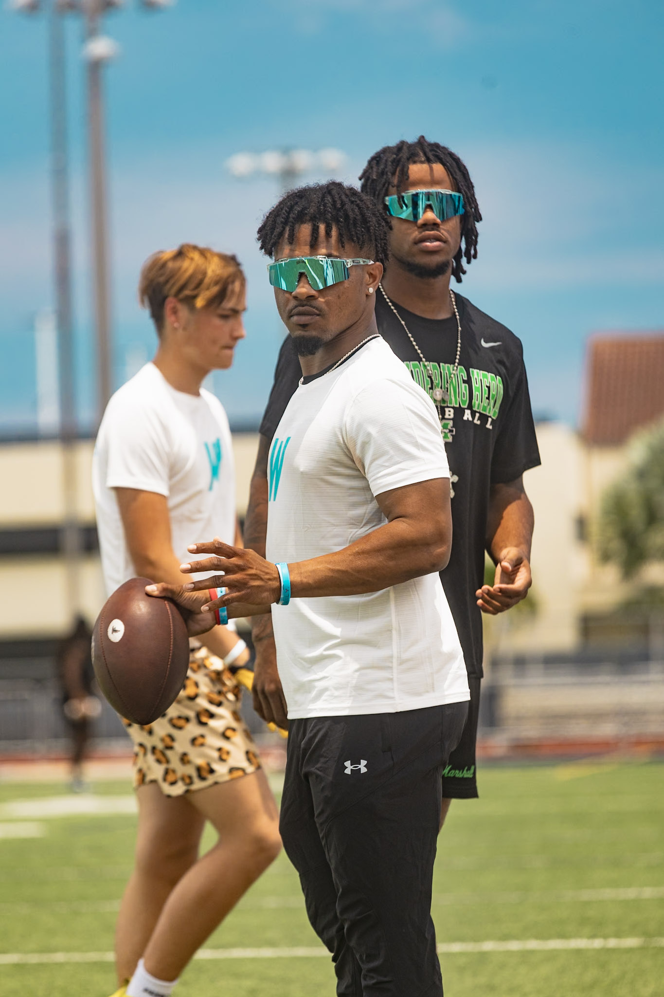 Two WeTrain trainers running passing drills at the camp